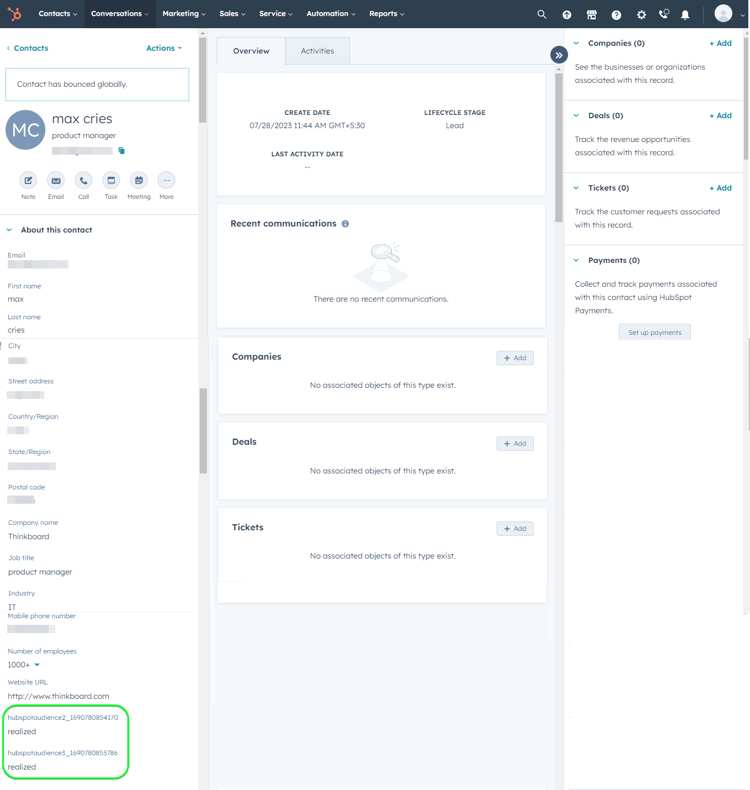 HubSpot UI screenshot showing the Contact page with custom properties displaying the audience name and audience statuses.